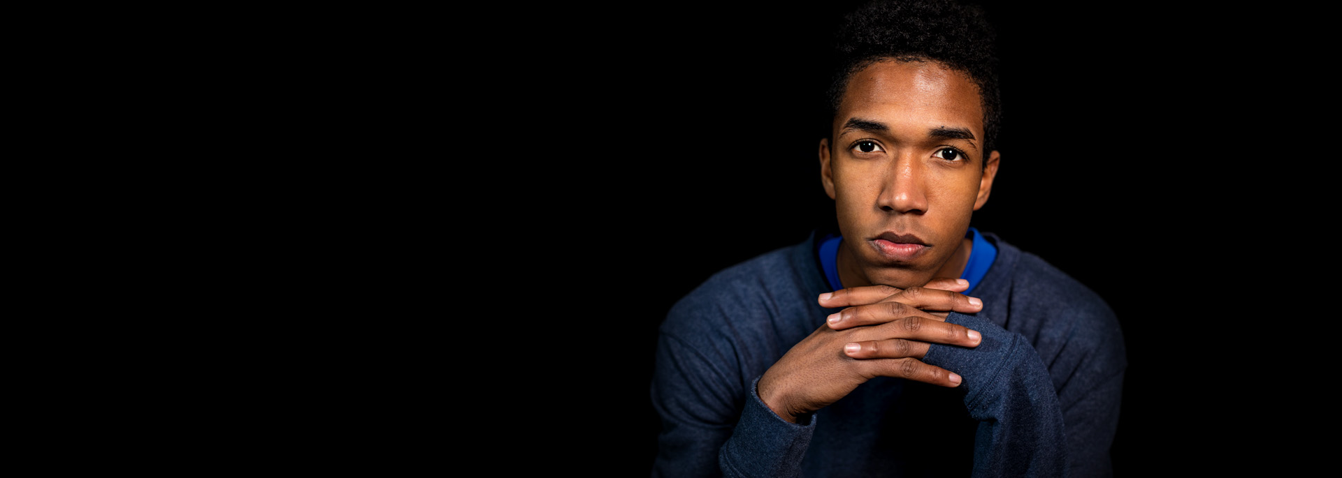 A young man looking toward the camera